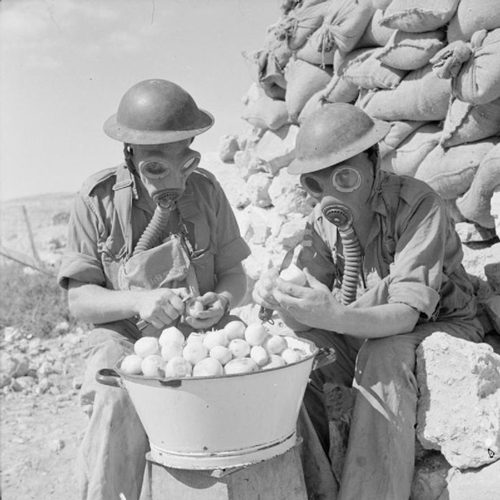 1940s Soldiers peeling onions with a gas mask